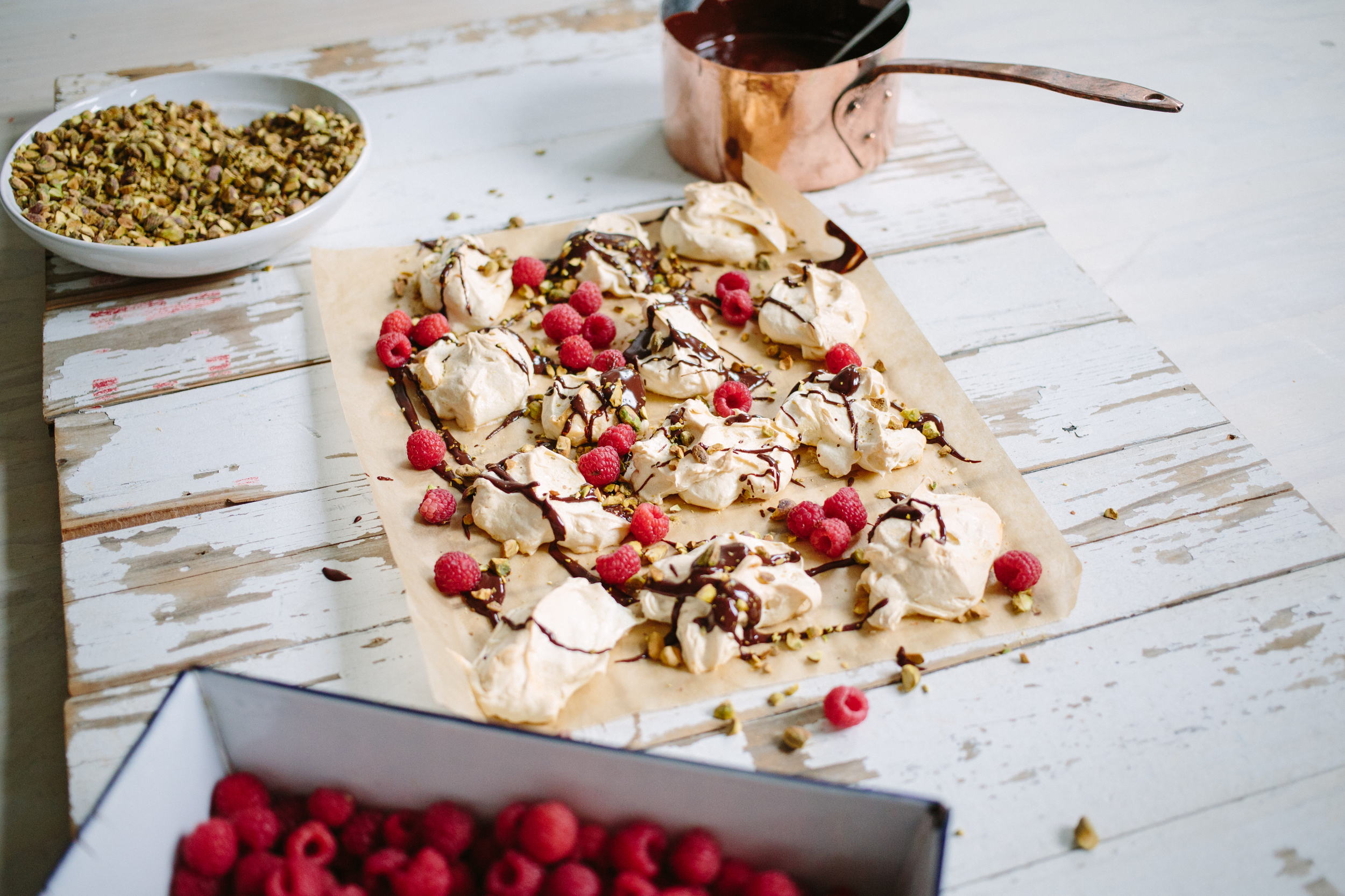 Vanilla Bean Pavlova with toasted pistachio, ganache& raspberries