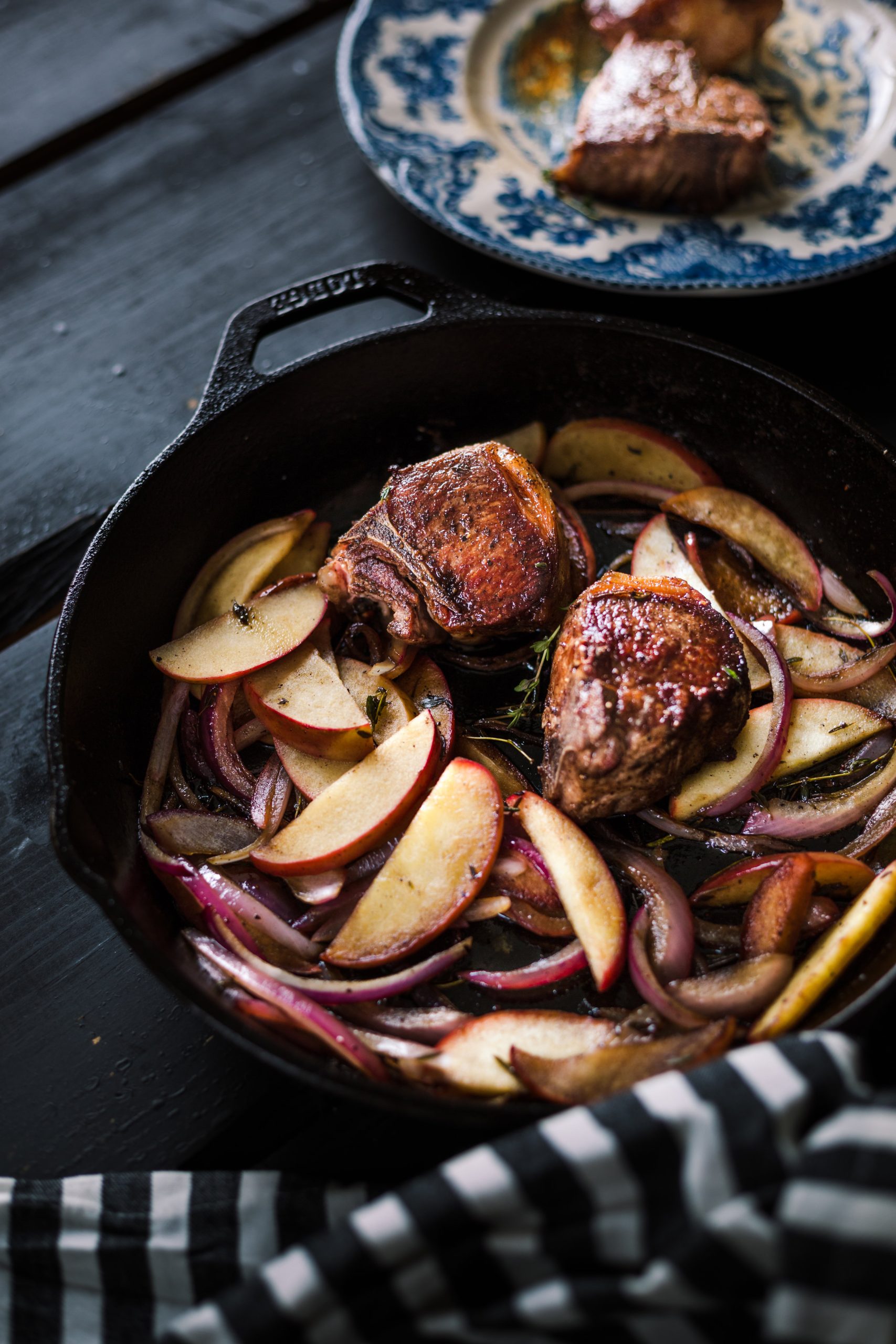 Cast iron lamb loin chops with sauteed apples and onions.