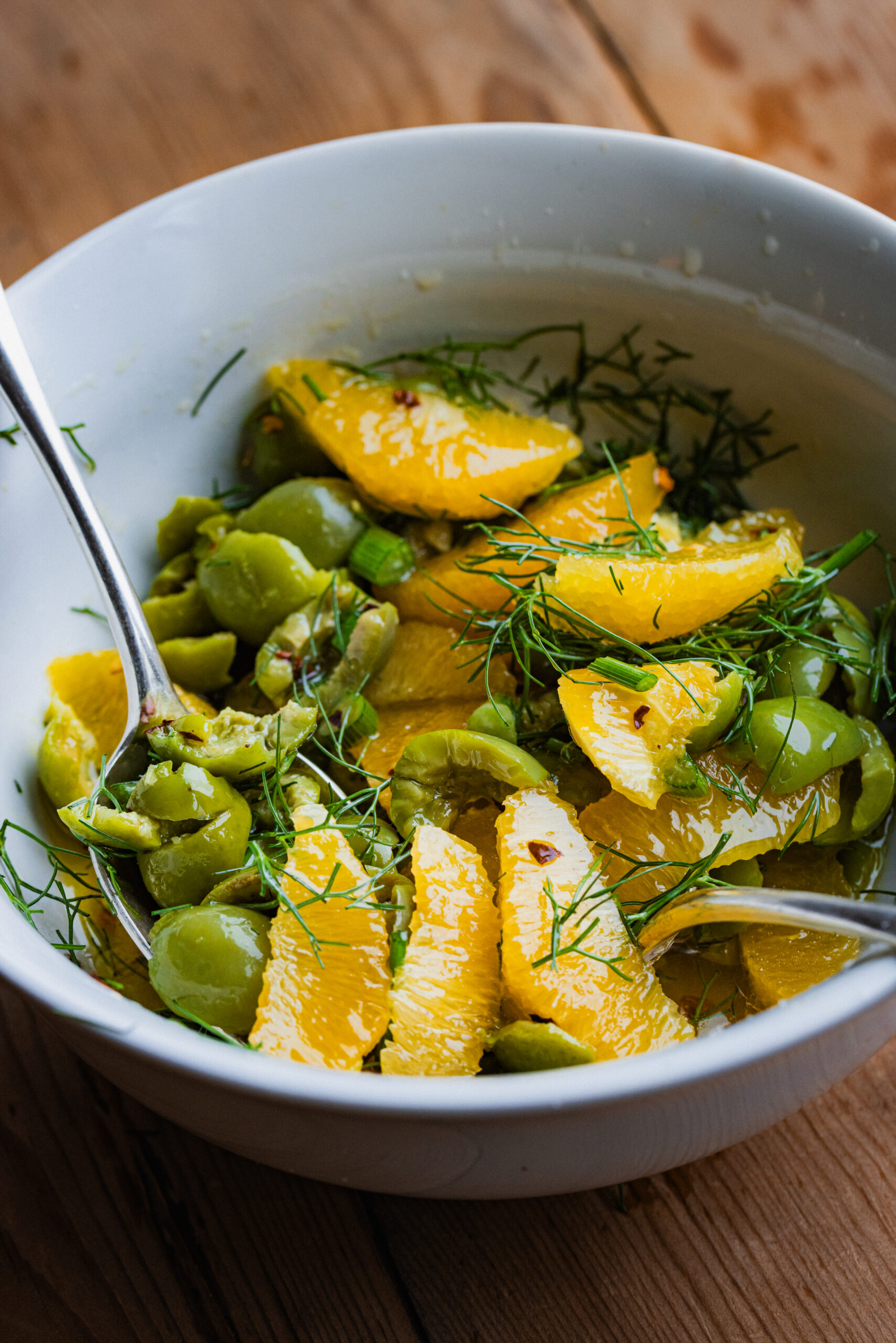 Olives, orange, and fennel in a bowl.